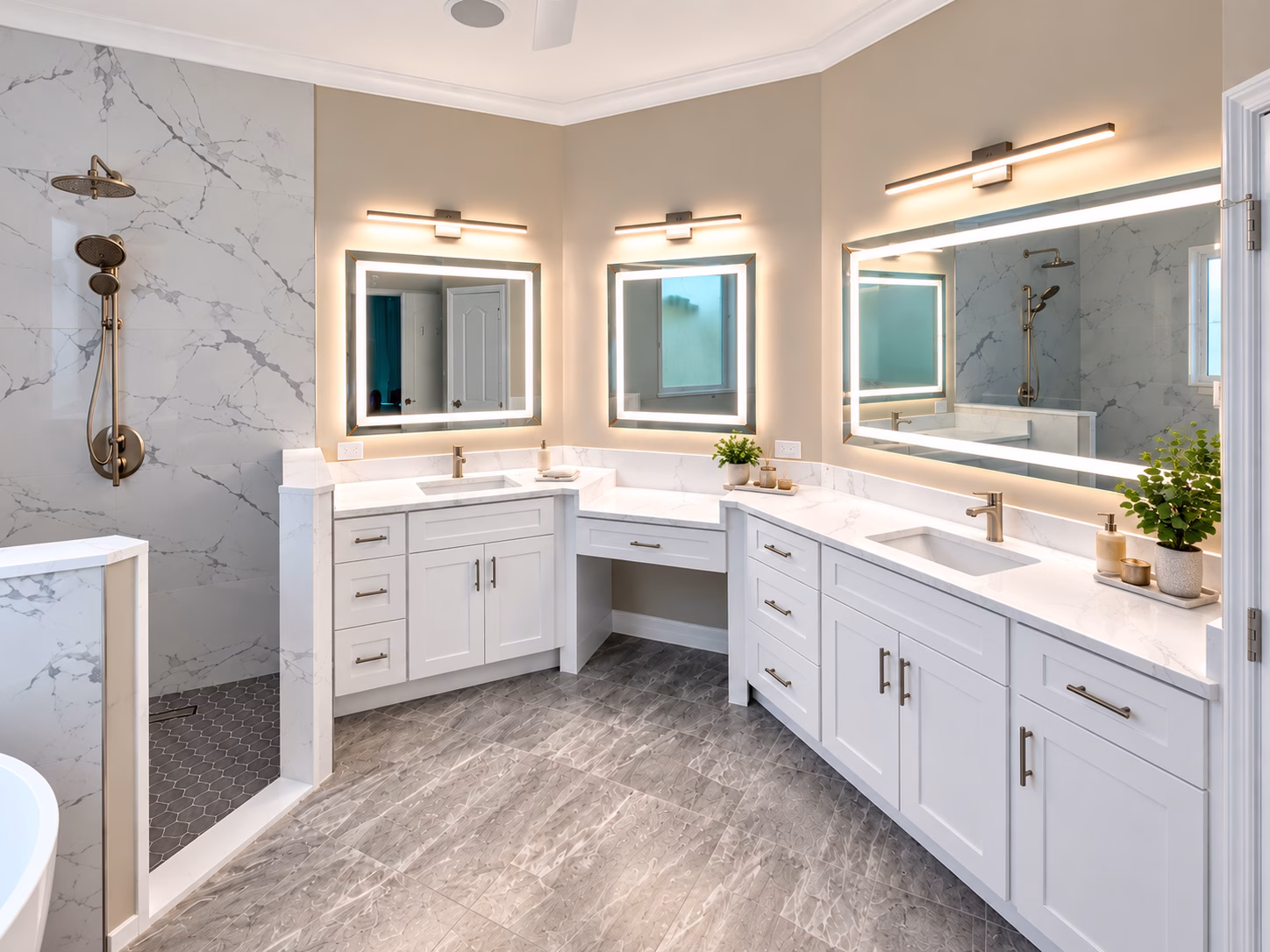 Master bathroom with marble-look walls, freestanding tub, backlit mirrors and double vanity, remodeled by BFM Builders