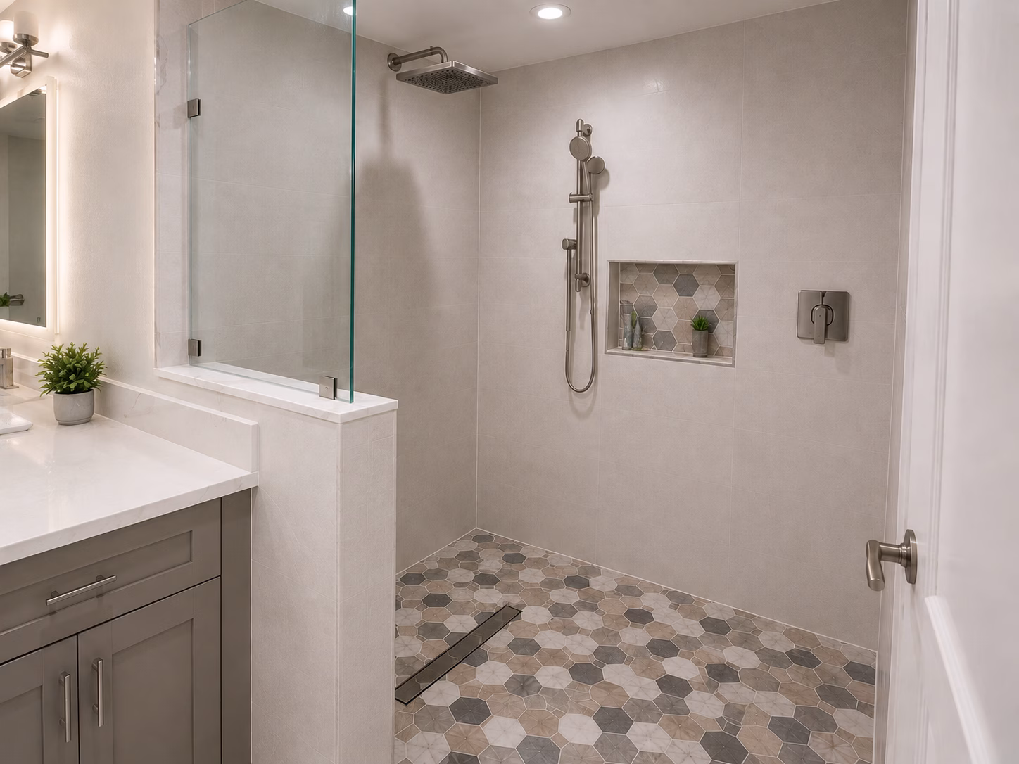 Open walk-in shower with a glass panel, niche and hexagon tile floor, remodeled by BFM Builders